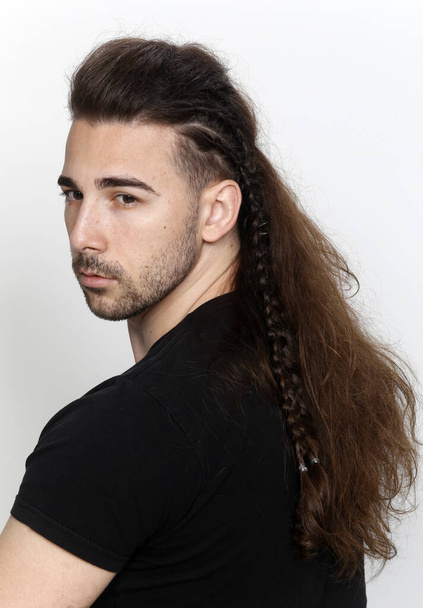 Stylish male model with braids posing in studio on isolated background. Style, hairstyle, fashion concept. - Foto, immagini