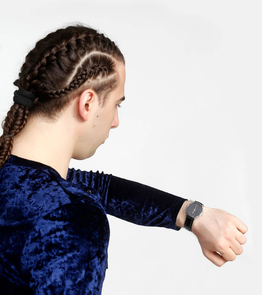 Attractive male model with braids posing in studio. Avantgarde, style, fashion concept. - Photo, Image
