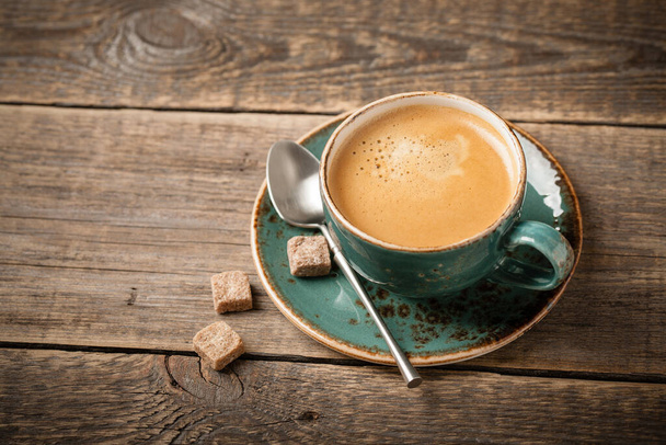 Cup of hot coffee on wooden table - Foto, Bild