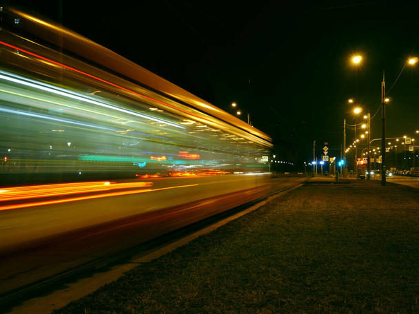 night tram red light trails motion blur passing by - Photo, Image