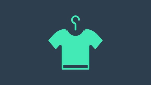 Turquoise T-shirt icon isolated on blue background. 4K Video motion graphic animation - Footage, Video