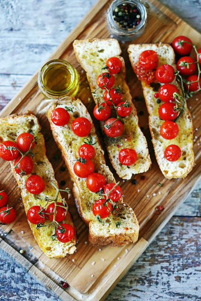 Delicious bruschetta with cherry tomatoes and olive oil. Greek or Italian food. - Photo, Image