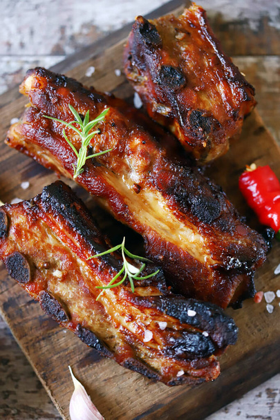 Appetizing hot ribs baked in honey mustard sauce with chili pepper. BBQ ribs. - Photo, Image