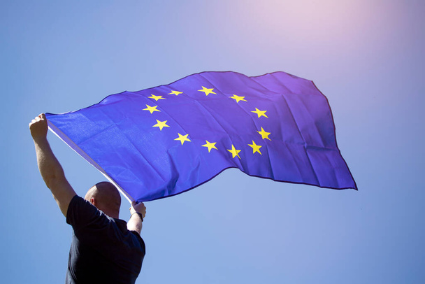 Young man holding European Union flag. Voting, election concept. - 写真・画像