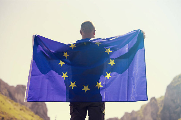 Young man holding European Union flag. Voting, election concept. - Valokuva, kuva