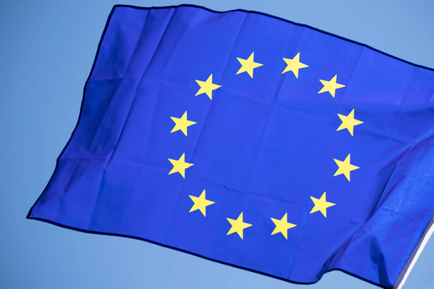 Waving European Union flag on blue sky. - Zdjęcie, obraz