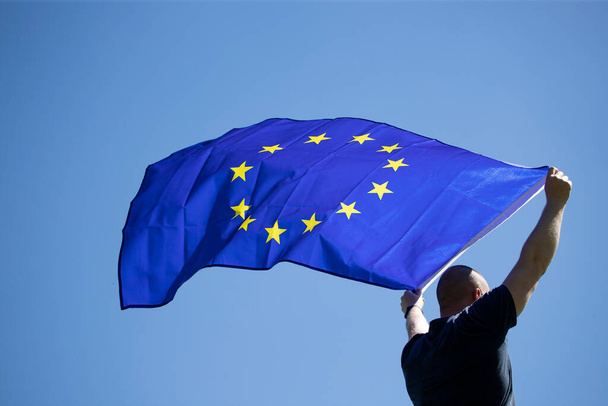 Young man holding European Union flag. Voting, election concept. - Fotografie, Obrázek