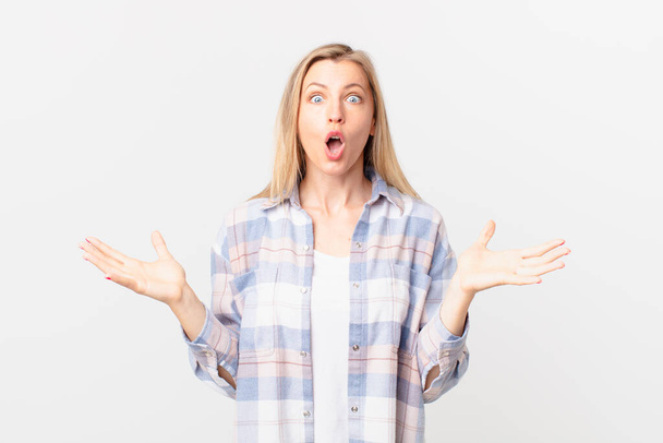 young blonde woman feeling extremely shocked and surprised - Фото, изображение