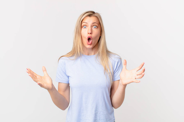 young blonde woman amazed, shocked and astonished with an unbelievable surprise - Fotoğraf, Görsel