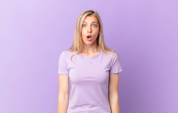 young blonde woman looking very shocked or surprised - Photo, Image