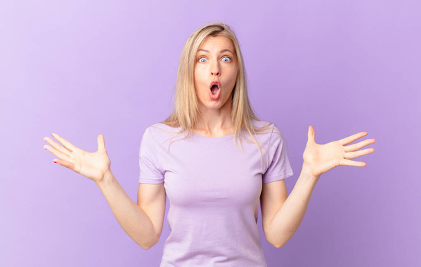 young blonde woman feeling extremely shocked and surprised - Foto, immagini