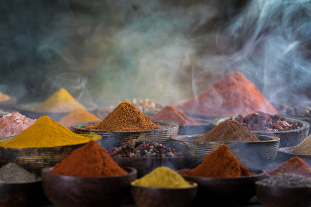 Assorted Spices and wooden bowl of smoke - Photo, Image