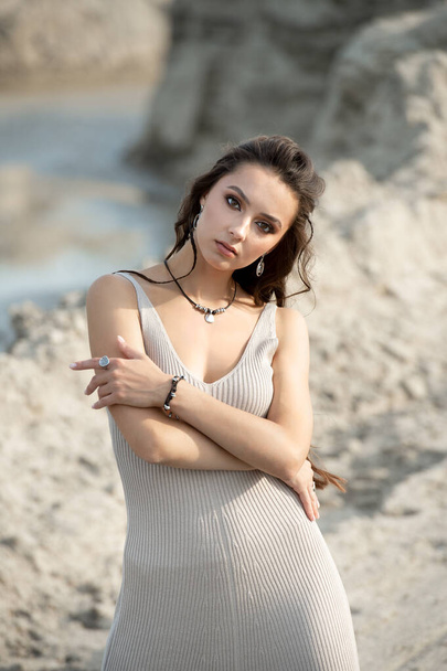 portrait of young sexy tanned beautiful woman standing on sand near the sea - Фото, зображення