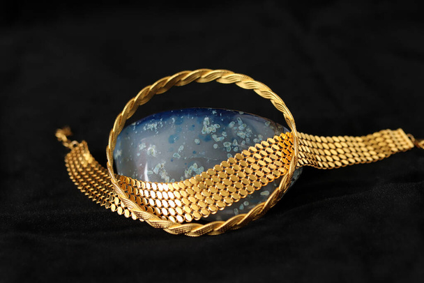 blue agate stone and gold bracelets - Fotoğraf, Görsel