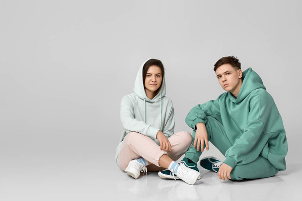 young couple wearing mint green casual hoodie - Фото, изображение