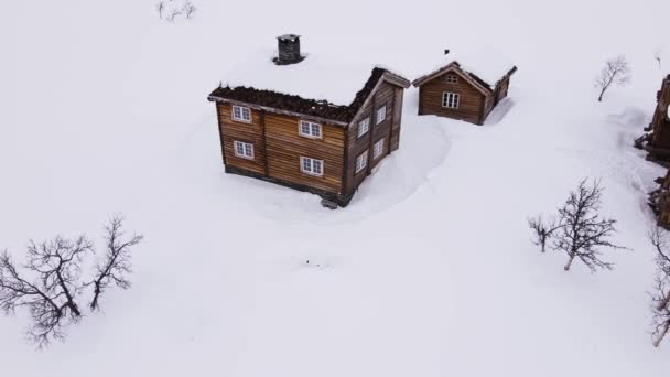 Traditional large classic log cabin in the mountains on a snowy cold winters day. 4K Aerial fly over. - Footage, Video