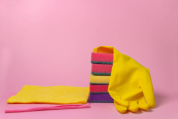 Cleaning tools on a pink background. Indoor cleaning tools. Dishwashing sponges. - Foto, afbeelding