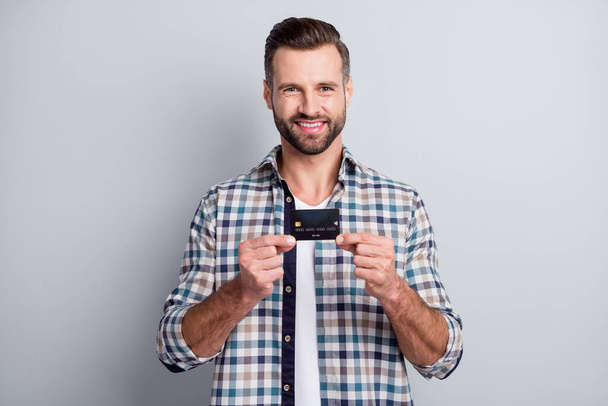 Photo portrait of cheerful man showing bank plastic card on shopping smiling isolated on grey color background - Fotoğraf, Görsel