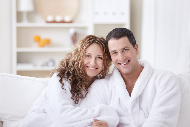 Laughing attractive couple in dressing gowns - Fotó, kép