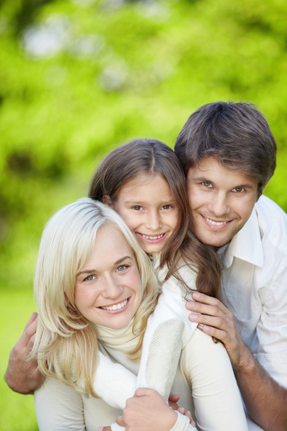 Attractive happy family with a child outdoors - Fotoğraf, Görsel