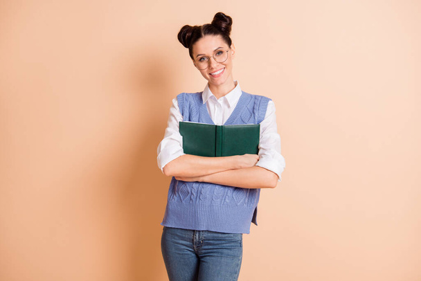 Photo of cute pretty young lady wear blue vest spectacles embracing open book isolated beige color background - Foto, Imagen