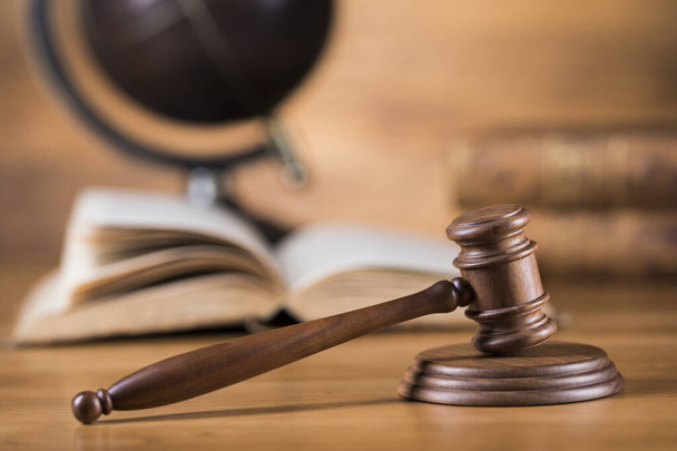 Law theme, mallet of judge, wooden gavel, globe background - Photo, Image