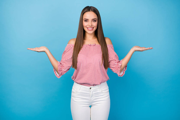 Portrait of positive promoter girl hold hand demonstrate offer wear good look clothes isolated over blue color background - Valokuva, kuva