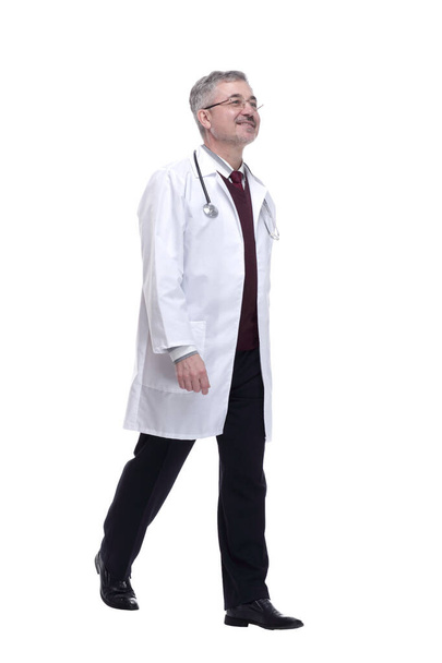 friendly doctor striding towards you. isolated on a white - 写真・画像