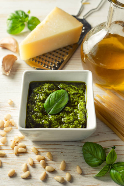 Homemade pesto sause with food ingredients on white wooden background - Foto, imagen