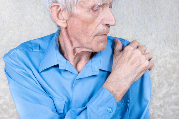 Eldery man suffering from pain in brachium. Male hand holding shoulder. Bone disease.  White background. - Fotoğraf, Görsel