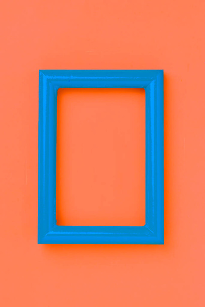 オレンジ色の壁に青い写真フレーム - 写真・画像