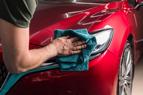 Polishing the headlight of a red car - Photo, Image
