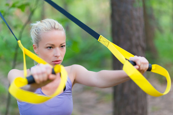 Training with fitness straps outdoors. - Photo, Image