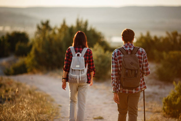 Porträt eines glücklichen jungen Paares, das Spaß beim Wandern hat. Kaukasisches und asiatisches Wandererpaar vergnügt sich im Sommerurlaub. Junge Leute wandern in der Natur. - Foto, Bild