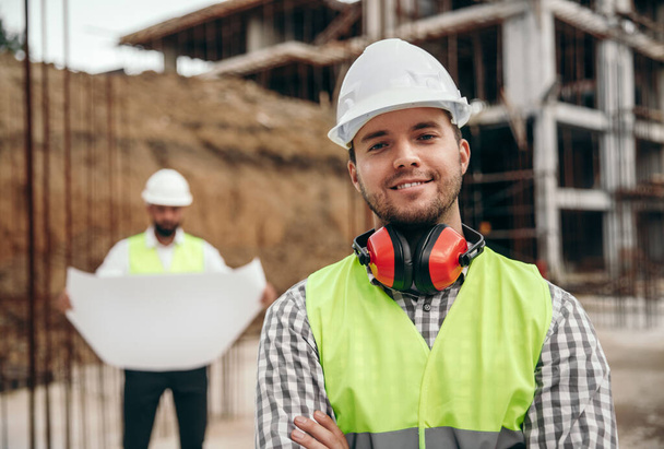 Smiling male builder at construction site - Photo, Image
