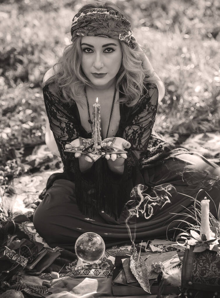 Gypsy soul... Boho woman with Tarot cards, candles and magic ball at field, lifestyle, predicting, ideas for costume on Halloween - Fotografie, Obrázek