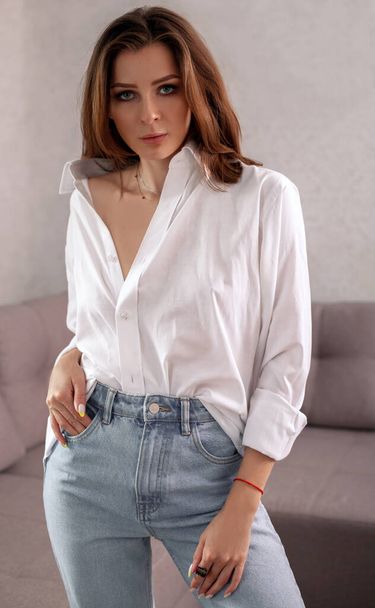 Fashionable woman in white shirt and jeans - Fotó, kép