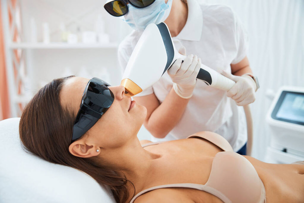 Patient getting an upper lip laser hair removal - Foto, afbeelding