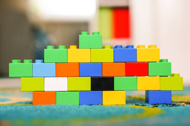 POZNAN, POLAND - Jul 08, 2016: Small colorful wall made of Lego Duplo blocks on a floor - 写真・画像