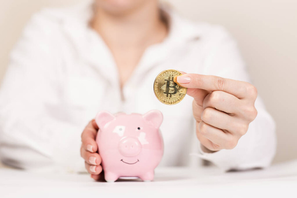 Piggy bank with bitcoin coin on light background, space for text. Finance, saving money - Photo, Image
