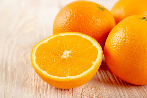 Juicy orange fruit on a wooden background. Healthy vegetarian food. - Foto, Imagem