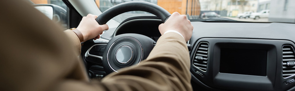 partial view of man in beige jacket driving car, banner - Foto, Bild