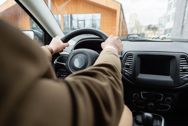 partial view of man in beige jacket driving car - Zdjęcie, obraz