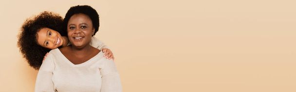happy african american grandmother embracing with granddaughter isolated on beige, banner - Фото, зображення