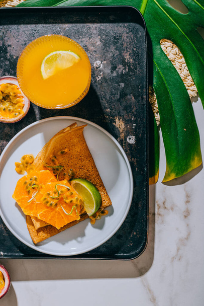 Crepes Or Thin Pancakes With Delicious passion fruit and lime. Summer tropical concept. - Photo, Image