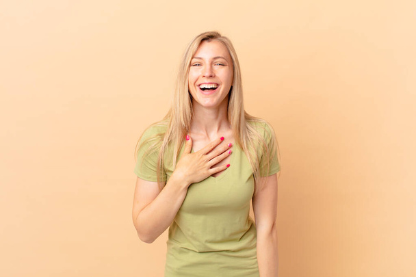 young blonde woman laughing out loud at some hilarious joke - Фото, изображение