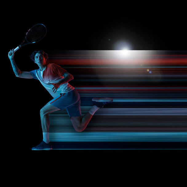 Abstract desing, concept of sport, action, motion in sport. Young caucasian male tennis player in neon light on black background - Foto, Imagen