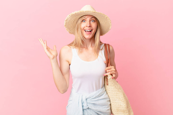 young blonde woman feeling happy, surprised realizing a solution or idea. summer concept - Photo, image