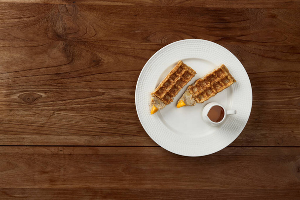 Oatmeal Belgian waffles in pencil shape on rustic wooden table. Flat lay top view - Photo, Image