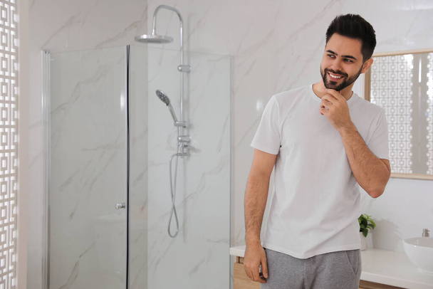 Handsome young man after shaving in bathroom, space for text - Photo, Image
